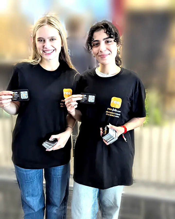 Two Reejob promoters with campaign cards inside the exhibition hall
